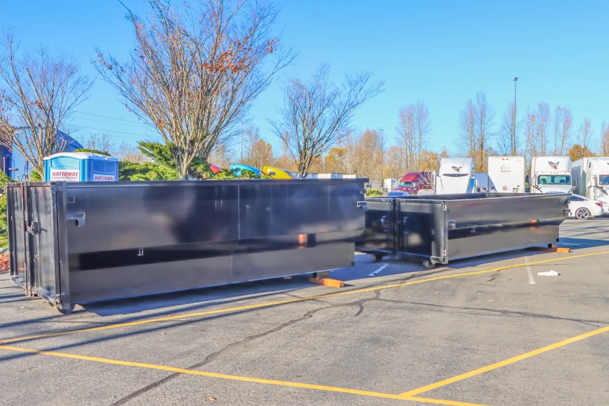 Professional dumpster rental service with roll-off container on residential driveway in Bellbrook
